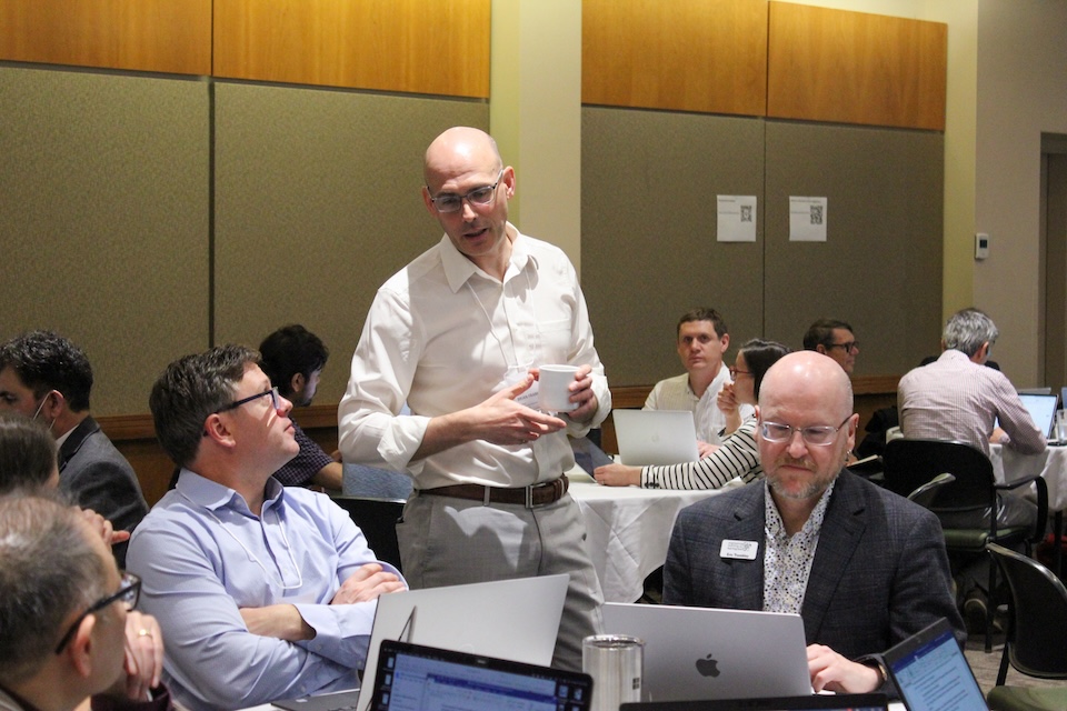people talking at symposium