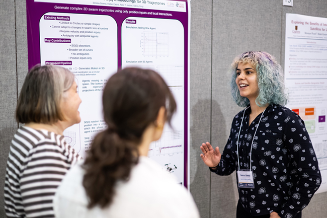 People standing in front of a research poster