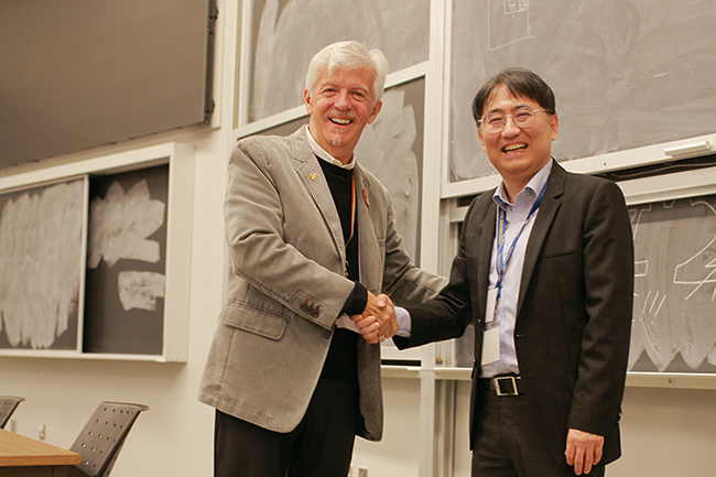 Stephen Rayment shakes hands with department head Il-Min Kim