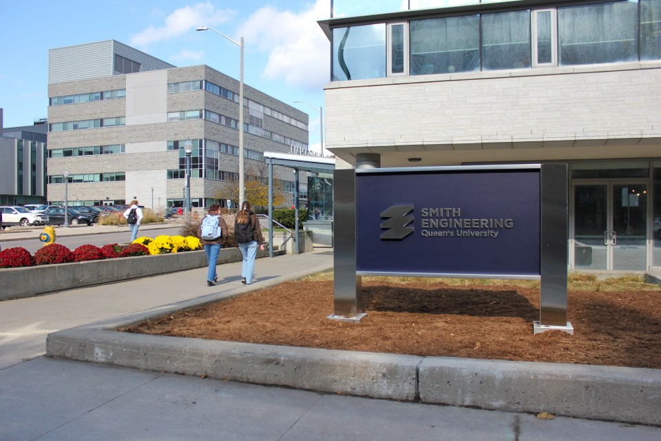 students walking by Smith Engineering sign